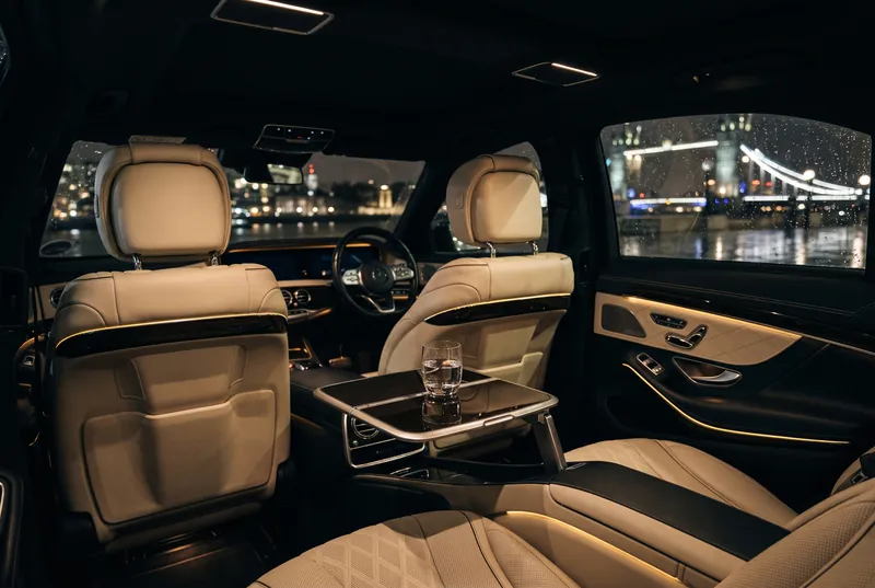 Rear cabin of a Mercedes-Benz S-Class at night with Tower Bridge outside
