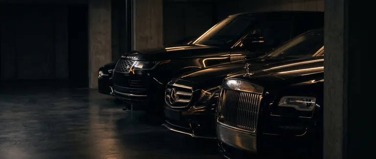 Row of black luxury chauffeur cars in a private garage