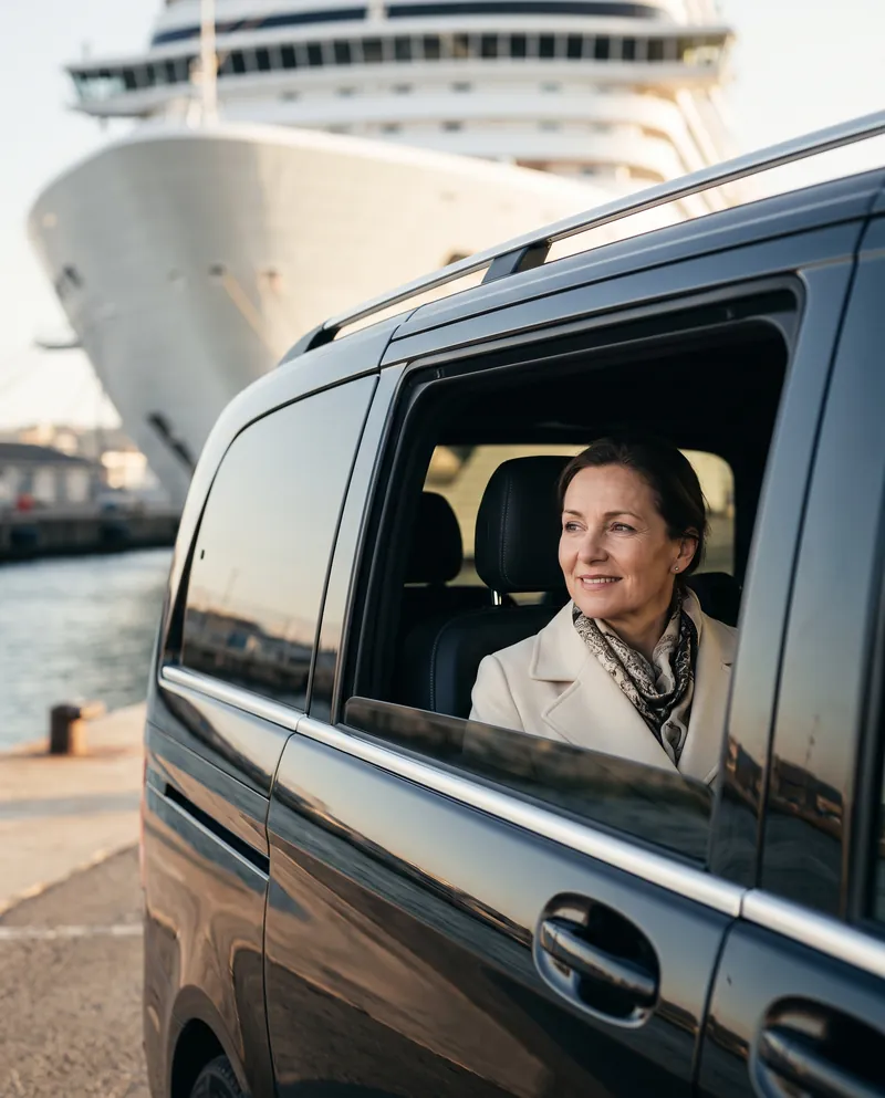 Woman looking at a cruise ship from a Mercedes-Benz V-Class